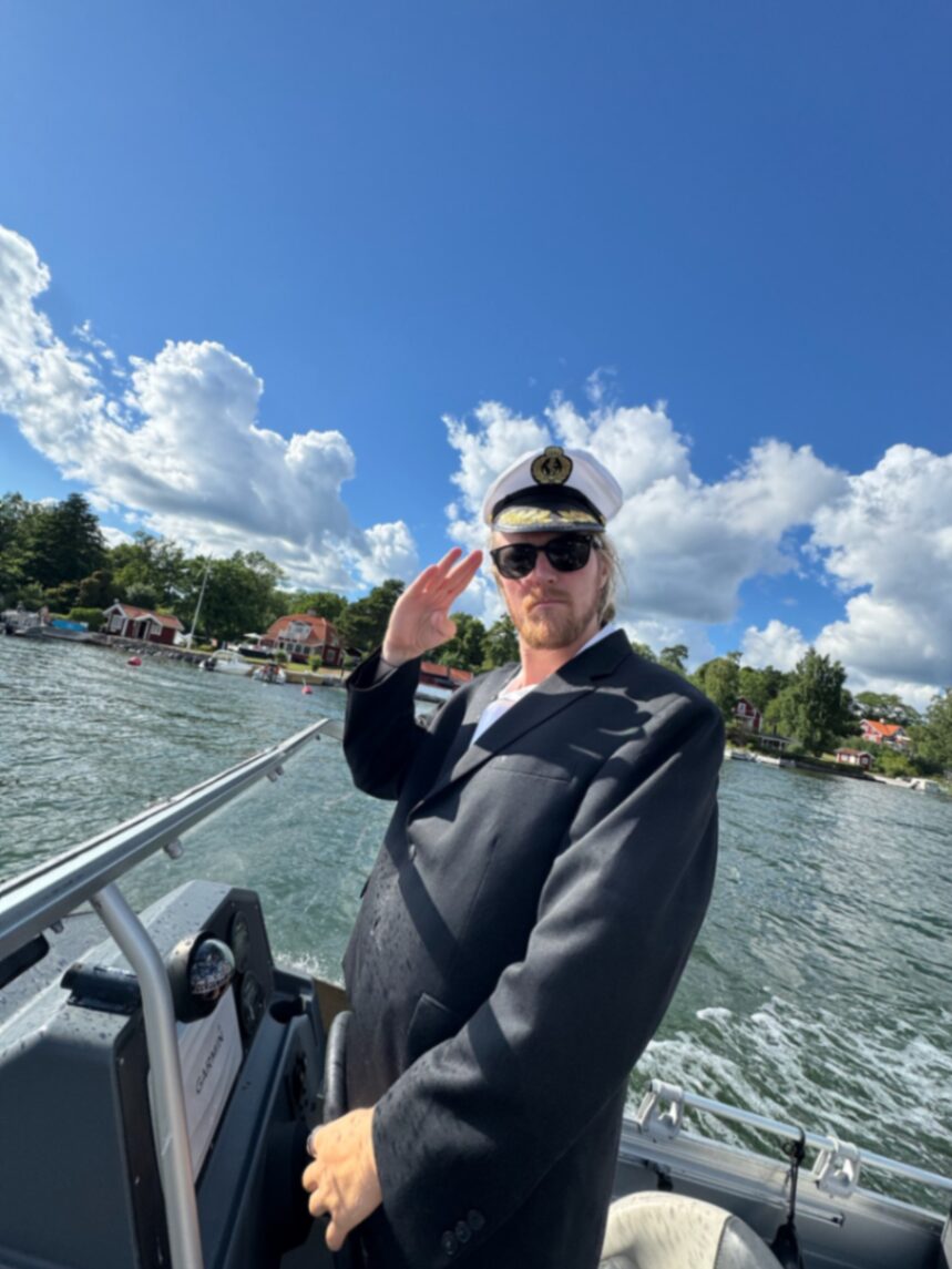 Captain saluting from the helm on a bright day